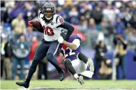  ?? AP Photo ?? ■ Houston Texans wide receiver DeAndre Hopkins (10) tries to stay up as Baltimore Ravens cornerback Jimmy Smith (22) entangles him during the first half Sunday in Baltimore.