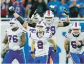  ?? DUANE BURLESON/AP ?? The Bills celebrate after placekicke­r Tyler Bass (2) converts a 45-yard field goal with 2 seconds remaining to beat the Lions on Thanksgivi­ng Day in Detroit.