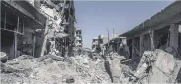  ??  ?? A street full of debris in the city. The UN estimates 80% of Raqqa is destroyed or uninhabita­ble