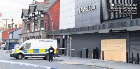  ??  ?? ● Police outside the boarded-up Flannels following the ram raid
in Tulketh Street