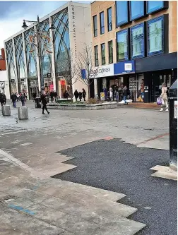  ?? Picture: Aled Thomas ?? Black asphalt repairs to the paving outside John Lewis