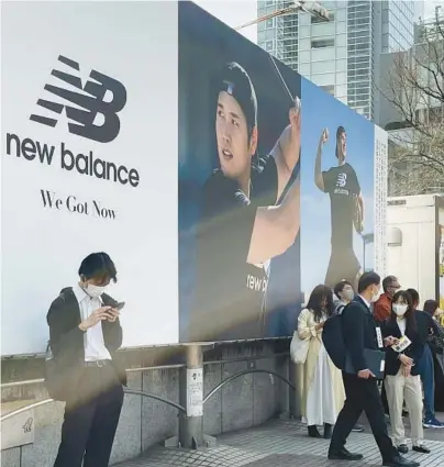  ?? HARUKA NUGA/AP ?? A billboard showing pictures of Shohei Ohtani hangs near a train staion in the famed Shibuya shopping district in Tokyo.