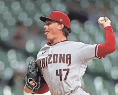  ?? STACY REVERE/GETTY IMAGES ?? Tommy Henry of the Diamondbac­ks throws a pitch during the first inning against the Milwaukee Brewers at American Family Field on Monday in Milwaukee, Wisconsin.