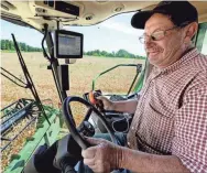  ?? MICHAEL SEARS/USA TODAY NETWORK ?? Bob Roden runs his combine on his farm in West Bend, Wis., 30 miles northwest of Milwaukee. The wet weather has been “another nail in the coffin” for some farms, he says.