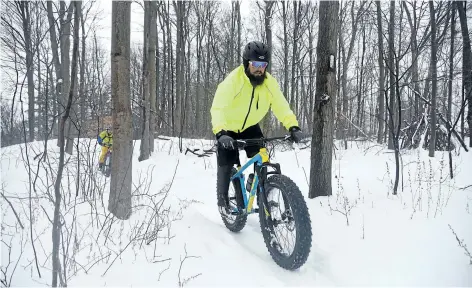  ?? CHERYL CLOCK/ STANDARD STAFF ?? A group of cyclist friends meets throughout the winter to ride the trails on their fat bikes. The specialize­d bikes are noted for their big tires that more easily grip and ride through the snow. Once rare and niche, the bikes are more mainstream.