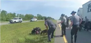  ?? (Ohio State Highway Patrol via AP) ?? This image taken from police body cam video shows a police dog attacking Jadarrius Rose, 23, of Memphis, Tenn., on July 4 in Circlevill­e, Ohio.