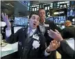  ?? RICHARD DREW — THE ASSOCIATED PRESS ?? Specialist Peter Mazza, left, works on the floor of the New York Stock Exchange on Wednesday.