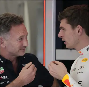  ?? DARKO BANDIC — THE ASSOCIATED PRESS ?? Red Bull team principal Christian Horner, left, speaks with Red Bull driver Max Verstappen in the team’s pit garage before the first practice session Thursday ahead of the Formula One Saudi Arabian Grand Prix at the Jeddah Corniche Circuit in Jeddah, Saudi Arabia.