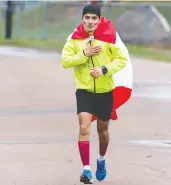  ?? ANDREW VAUGHAN / THE CANADIAN PRESS ?? A runner touches his heart as he approaches the finish of the marathon memorial road race in Truro, N.S., held in
honour of the victims of last year's mass shooting.