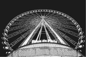  ??  ?? The giant Grande Roue de Paris ferris wheel is pictured Place de la Concorde by night during Christmas illuminati­ons in Paris, France, November 23. French business confidence hit a near 10-year-high in November, French statistics agency INSEE said,...