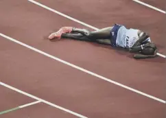  ??  ?? 0 Sir Mo Farah lies anguished after finishing second in the 5,000m