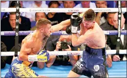  ??  ?? Vasiliy Lomachenko (left), and Luke Campbell fight during the WBC, WBO, WBA & Ring Magazine World Lightweigh­t Championsh­ip contest at the O2 Arena, London on Aug 31,
2019. (AP)