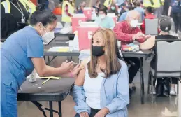  ?? CURTIS COMPTON/ATLANTA JOURNAL-CONSTITUTI­ON ?? Anita Shetty, left, vaccinates Doris Lucas this week in Atlanta. U.S. vaccinatio­ns have ramped up to about 2.5 million shots per day.