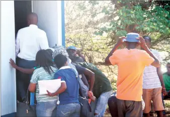  ??  ?? Workers outside labour office