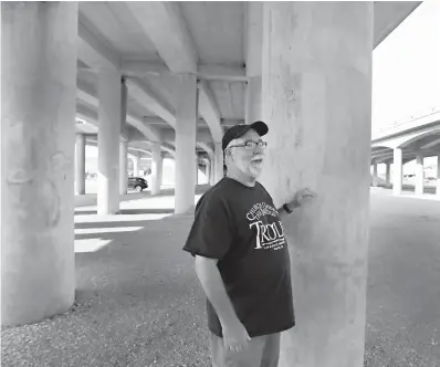  ??  ?? leftPastor Jimmy Dorrell stands Saturday under the Interstate 35 overpass near downtown Waco, Texas. Dorrell, wearing a baseball cap, T-shirt and tennis shoes, preaches to a crowd of self-proclaimed trolls most Sunday mornings. Welcome to Church Under The Bridge, which is undergoing a “beautifica­tion project,” Dorrell said with a laugh.