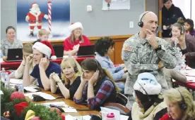  ?? —AP Photos ?? COLORADO: In this file photo, NORAD and US Northern Command (USNORTHCOM) Chief of Staff Maj. Gen. Charles D. Luckey joins other volunteers taking phone calls from children around the world asking where Santa is and when he will deliver presents to...