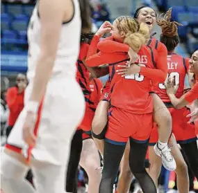  ?? Jessica Hill/Associated Press ?? St. John’s players celebrate their 69-64 win over UConn on Tuesday.