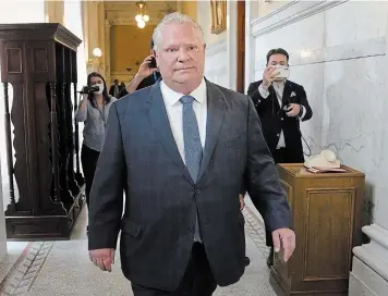  ?? ?? Ontario Premier Doug Ford walks to visit Lt.-gov. Elizabeth Dowdeswell's office at Queen's Park in Toronto, Tuesday. The meeting officially started the provincial election period.