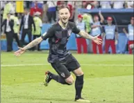  ?? Kevin C. Cox / Getty Images ?? Ivan Rakitic celebrates scoring the winning penalty to give Croatia a quarterfin­al victory over the host team, Russia, on Saturday. The Croats advance to face England in the semifinals on Wednesday.