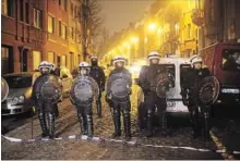  ?? CARL COURT GETTY IMAGES ?? Police patrol after raids in which several people, including Salah Abdeslam, were arrested in 2016 in Sint-Jans-Molenbeek, Belgium.