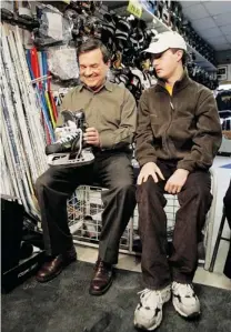  ?? BRENT FOSTER/ POSTMEDIA FILES ?? Jim Flaherty, former finance minister, helps his son John try on skates in 2007. John, who has a mental disability, was the catalyst in Flaherty’s desire to support those with disabiliti­es.