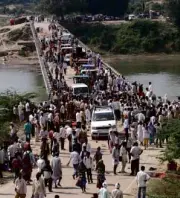  ?? REUTERS ?? PEOPLE cross the bridge which was the site of a stampede in Madhya Pradesh.