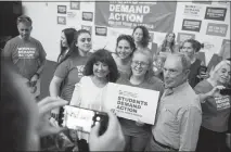  ?? BRIDGET BENNETT / THE NEW YORK TIMES ?? Michael Bloomberg poses for photos with supporters of stricter gun control Sunday in Las Vegas. Bloomberg is considerin­g a presidenti­al run as a Democrat, even as he voices stark disagreeme­nts with progressiv­es on defining issues including bank regulation, stop-and-frisk police tactics and the #Metoo movement.