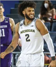  ?? TONY DING — THE ASSOCIATED PRESS ?? Isaiah Livers and unbeaten Michigan (9-0) jumped from
No. 16 to No. 10 in this week’s Associated Press Top 25 poll.