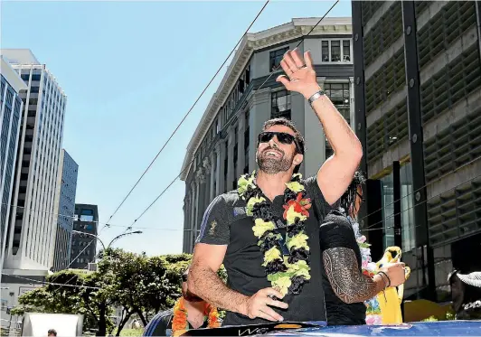  ?? PHOTOS: GETTY IMAGES ?? Conrad Smith laps up the celebratio­ns during an All Blacks victory parade after the 2015 World Cup win, one of two cup triumphs the Hurricanes centre has enjoyed.