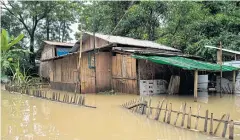  ?? BY AFP PHOTOS ?? BELOW A home is surrounded by floodwater­s in Bago region yesterday. Fears that embankment­s could burst under fresh rains mounted in flooded southeaste­rn Myanmar.