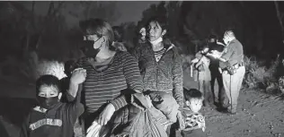  ?? Jerry Lara / Staff file photo ?? A Hidalgo County deputy constable guides migrant families in February to a U.S. Border Patrol processing area in Mission, where the mostly Central American families surrendere­d.