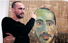  ?? ?? ARTIST Mostafa Azimitabar speaks about his work, titled Self-Portrait, as the finalists’ work for the Archibald Prize was displayed in Sydney yesterday. | AFP