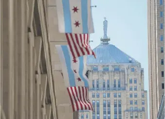  ?? SUN-TIMES FILE ?? Chicago City Hall, with the Board of Trade building in the background on La Salle Street.