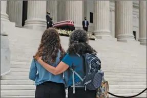  ?? (The New York Times/Michael A. McCoy) ?? People pay their respects Thursday to Supreme Court Justice Ruth Bader Ginsburg as her body lies in repose outside the Supreme Court building.