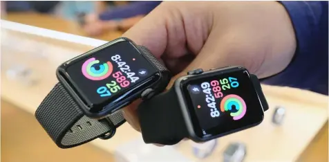  ?? RICHARD VOGEL/AP ?? An Apple store employee shows a customer the new Apple Watch Series 2 at the Apple Store at the Grove in Los Angeles.