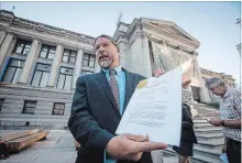 ?? DARRYL DYCK
THE CANADIAN PRESS ?? Jay Ritchlin, David Suzuki Foundation director-general for Western Canada, holds a copy of a lawsuit conservati­on groups filed.