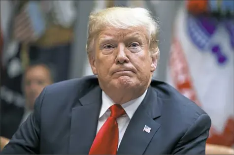  ?? Evan Vucci/Associated Press ?? President Donald Trump listens to a question from a reporter on Monday during a meeting of the President’s National Council of the American Worker in the Roosevelt Room of the White House.