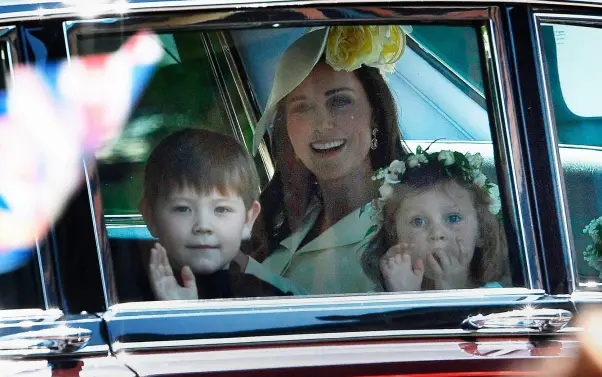  ??  ?? JUST DON’T BE LATE: Kate Middleton, Duchess of Cambridge (centre) arrives with Princess Charlotte (right) and bridesmaid­s for yesterday’s wedding ceremony