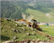  ??  ?? A JCB digs the Sonamarg meadow, with hotels seen behind.