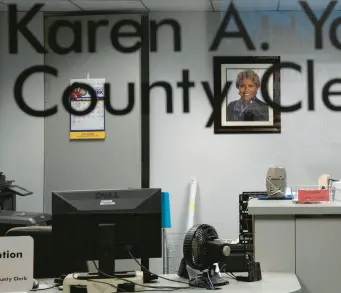  ?? ERIN HOOLEY/CHICAGO TRIBUNE ?? A photo of Cook County Clerk Karen Yarbrough hangs in her office in 2019.