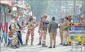 ?? PTI ?? Police personnel stand guard on a road at Banbhulpur­a area.
