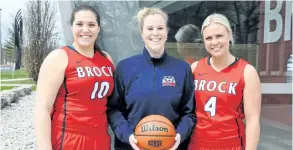  ?? PHOTO COURTESY BROCK SPORTS ?? Welland natives Courtney McPherson, left, and Brooke-Lyn Murdoch flank Brock University women’s basketball head coach Ashley MacSporran after opting to transfer from Niagara College for their final year of eligibilit­y at the post-secondary level.