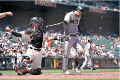  ?? AP Photo/Eric Risberg ?? ■ Arizona Diamondbac­ks’ Carson Kelly walks back to the dugout after striking out swinging against San Francisco Giants starting pitcher Kevin Gausman during the seventh inning of a game Thursday in San Francisco. At left is Giants catcher Curt Casali.