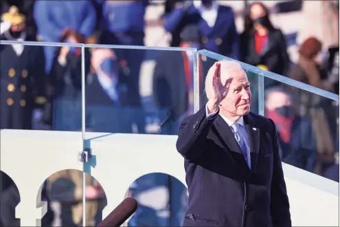  ?? Tasos Katopodis / Associated Press ?? President Joe Biden reacts as he prepares to deliver his inaugural address on the West Front of the U.S. Capitol on Wednesday in Washington.