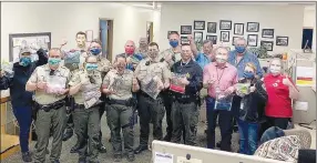  ?? COURTESY PHOTO ?? Staff with Washington County Sheriff’s Office show off their masks they received from Washington County Extension Homemakers Council, Master Gardeners and 4-H members.