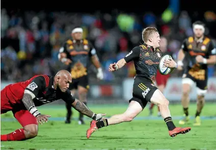  ?? GETTY IMAGES ?? Damian McKenzie, skipping away from Nemani Nadolo, was a crucial factor in the Chiefs’ vital win over the Crusaders in Fiji.