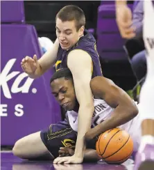  ?? Elaine Thompson / Associated Press ?? Cal's Grant Anticevich and Washington's Noah Dickerson fight for a loose ball during the first half in Seattle.