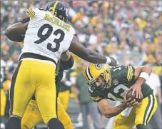  ??  ?? Daniel McCullers pressures quarterbac­k Aaron Rodgers. Coach Mike Tomlin praised McCullers’ work in camp.