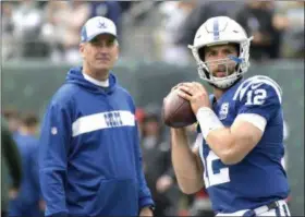  ?? BILL KOSTROUN - THE ASSOCIATED PRESS ?? FILE - In this Oct. 14, 2018, file photo, Indianapol­is Colts quarterbac­k Andrew Luck (12) warms up as head coach Frank Reich looks on prior to an NFL football game against the New York Jets, in East Rutherford, N.J.