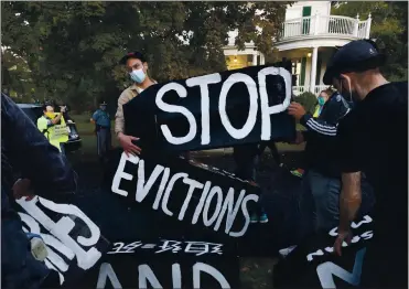  ?? MICHAEL DWYER — THE ASSOCIATED PRESS ARCHIVES ?? Housing activists erect a sign in front of Massachuse­tts Gov. Charlie Baker’s house in Swampscott, Massachuse­tts. The latest round of aid for renters was included in the $1.9 trillion relief package pushed through Congress in March.